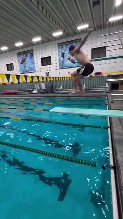 Man knocks down pool flags while attempting dive