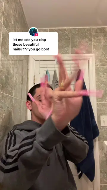 Watch these pink acrylic nails clap and dance in the mirror