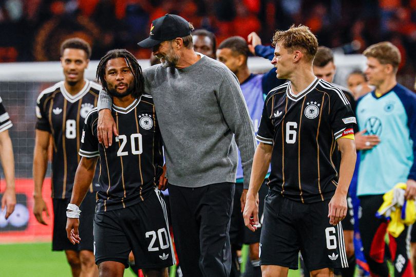 Jurgen Klopp speaks with players after his Germany manager debut