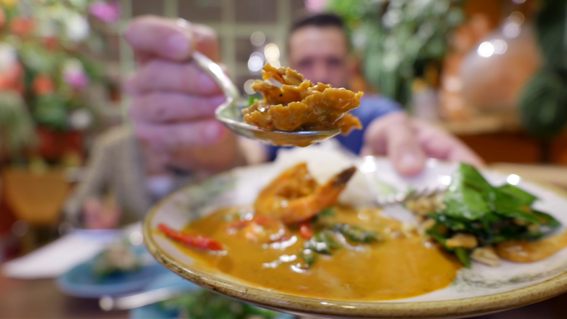 Tasting fiery southern Thai curry with prawns stink beans and mushrooms