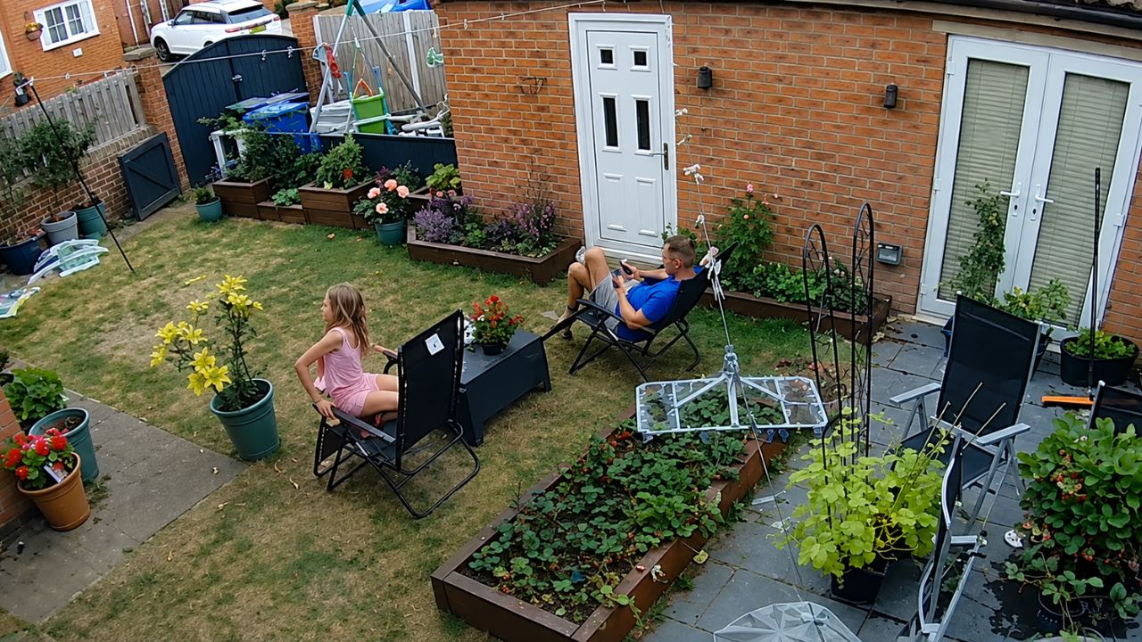 Girl falls backward as her garden chair tips over