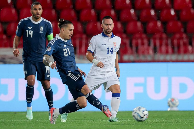 Greece's defender #21 Kostas Tsimikas and Serbia's midfielder #14 Andrija Zivkovic (R) fight for the ball during the UEFA Nations League phase group A2 football match between Serbia and Greece at the Rajko Mitic Stadium