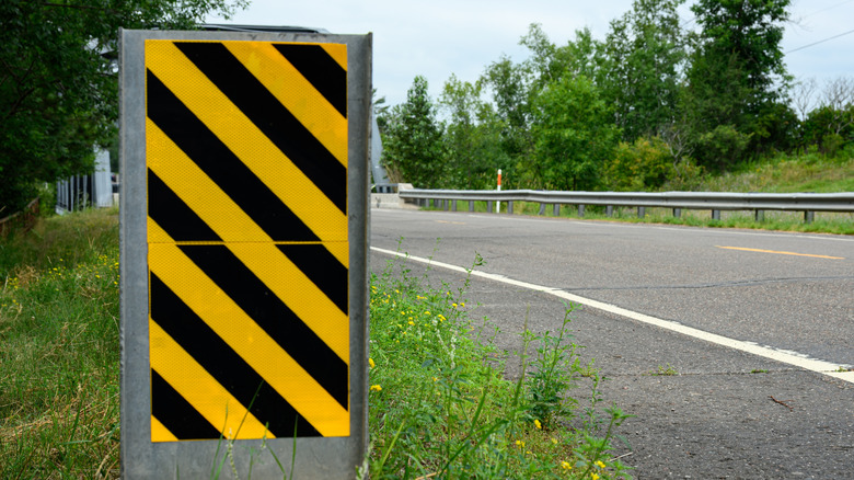 Here's what those diagonal black and yellow striped road signs are ...