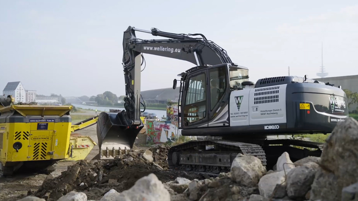 Heavy excavator crushing massive rocks on site