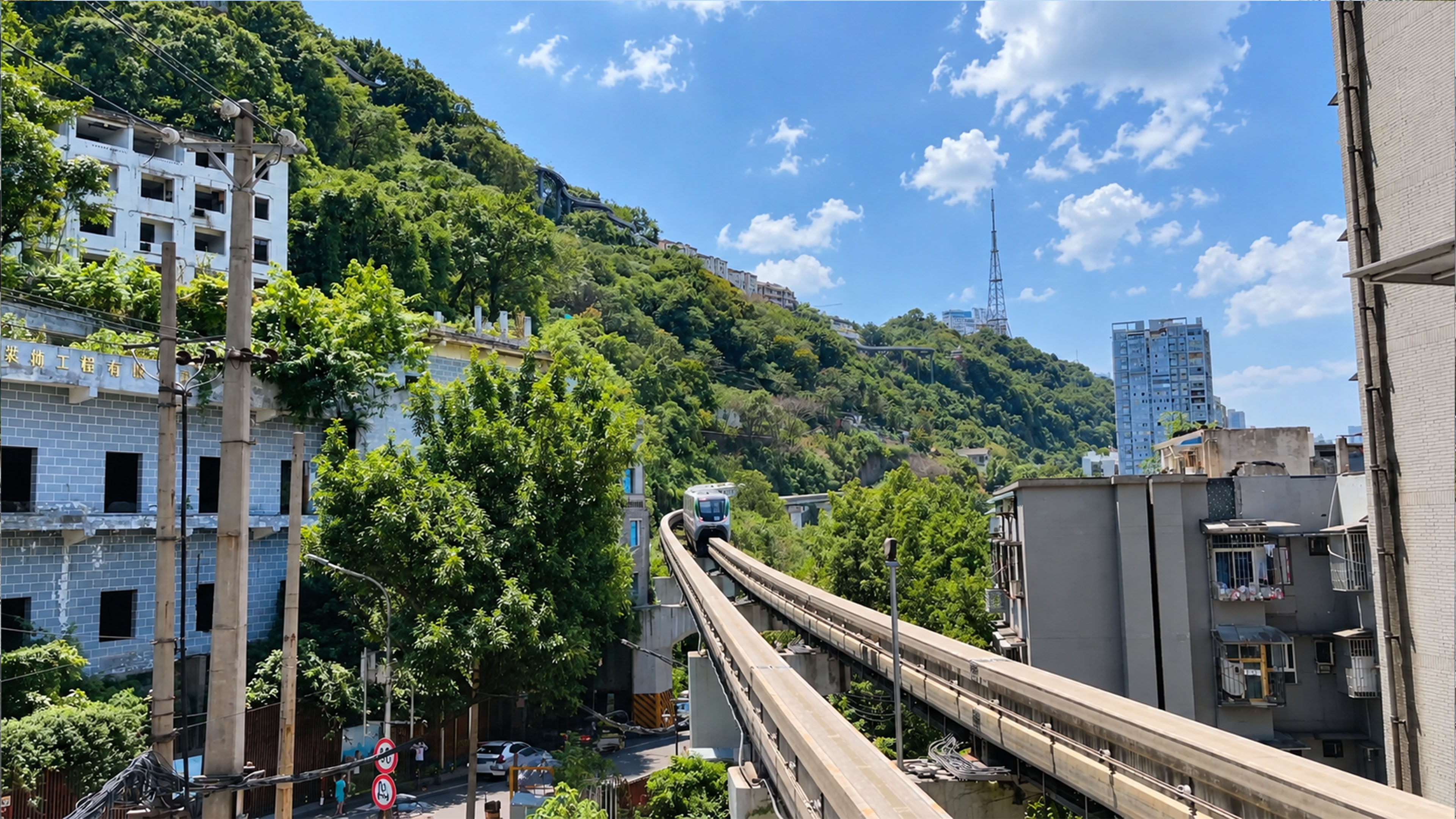 A train in China emerges between Chongqing hillside buildings
