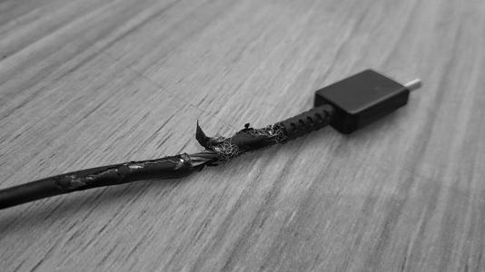 A damaged USB cable showing signs of wear