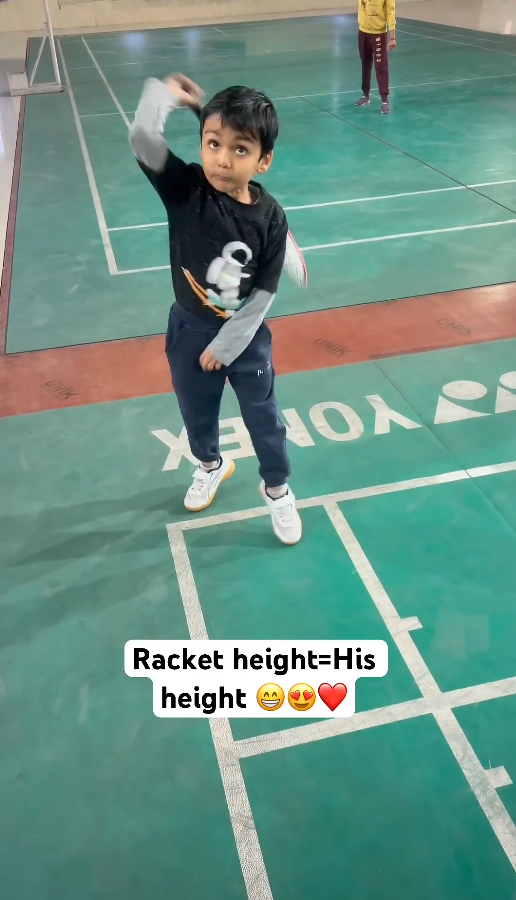 When the badminton racket matches his height