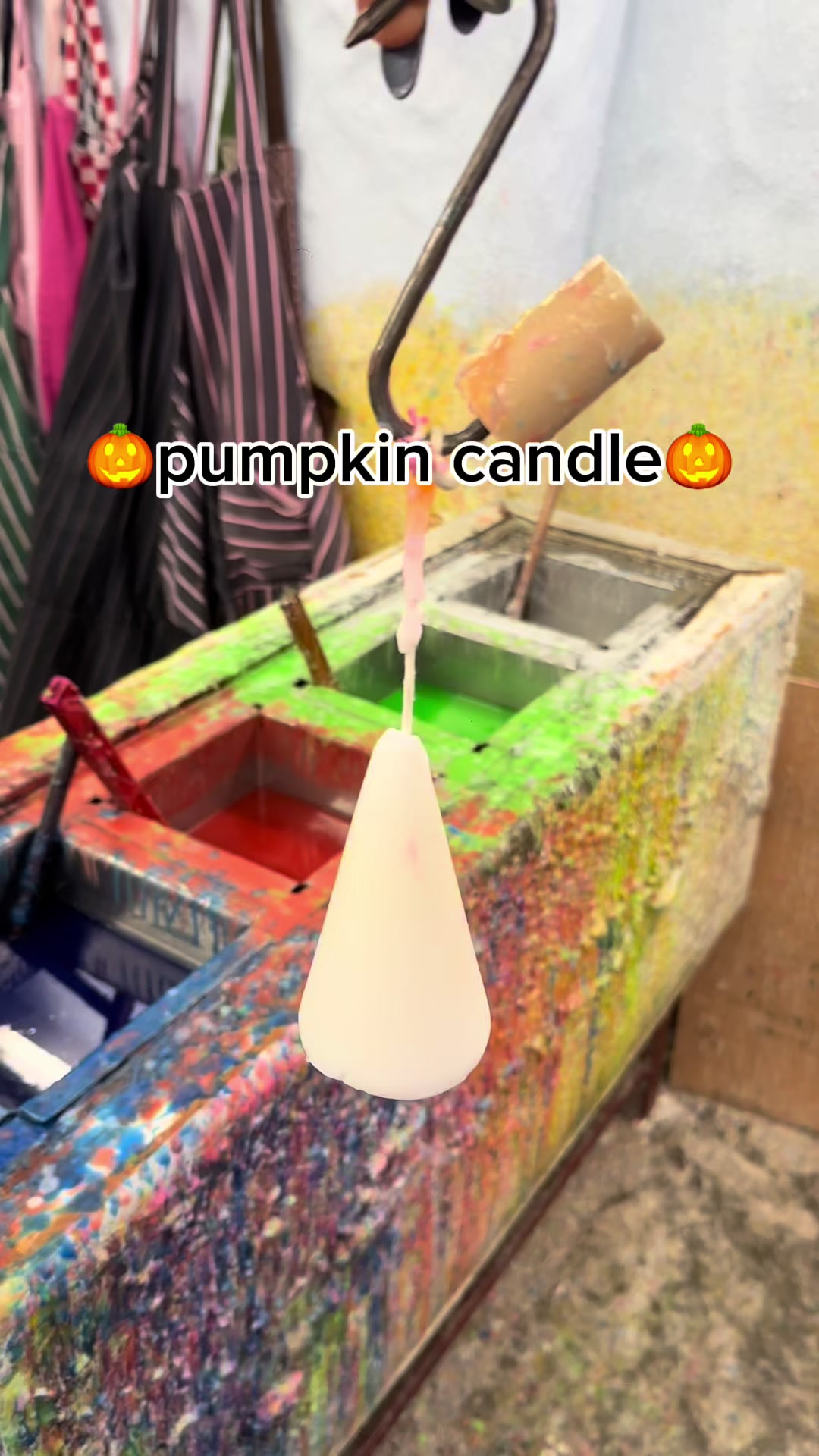 Wax dipping a cone shaped candle