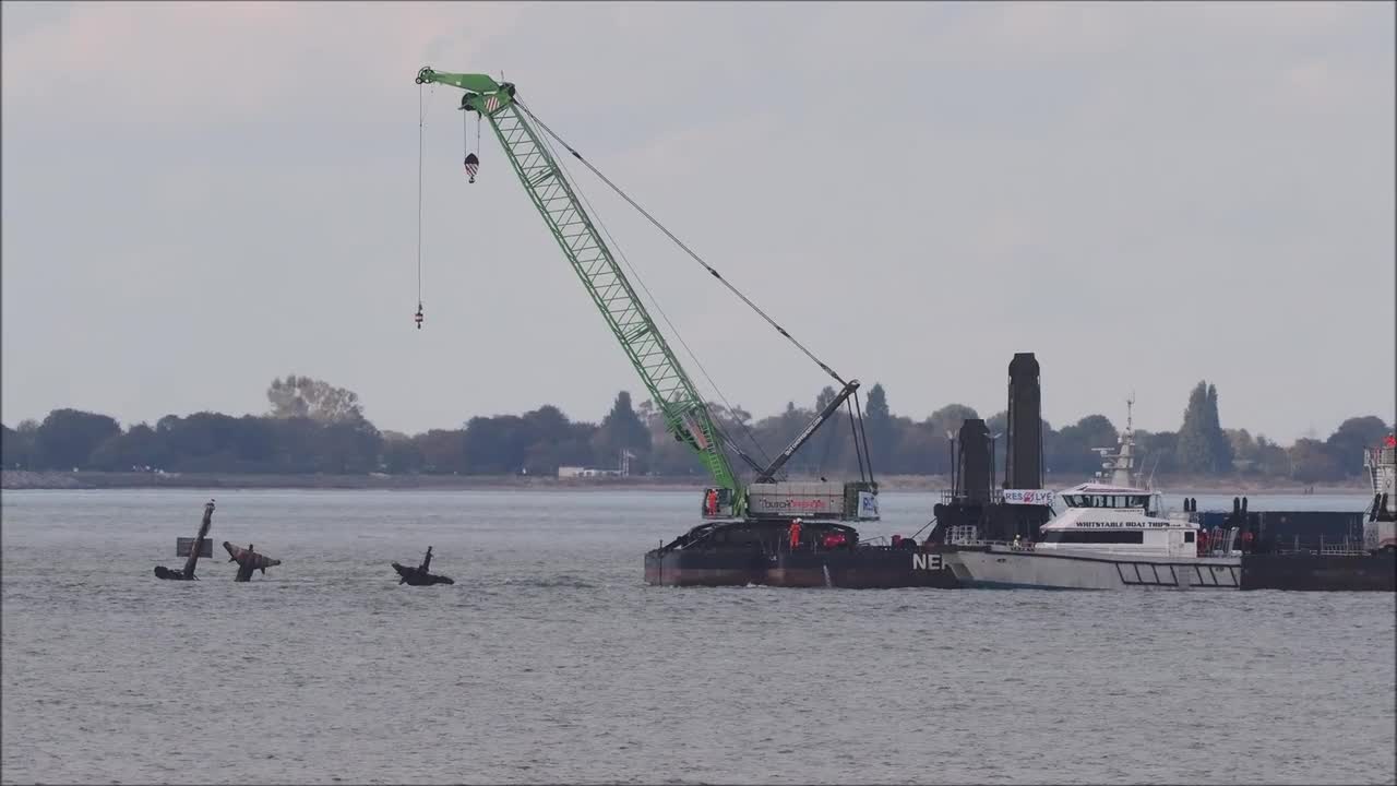 Crane barge inched into position next to Thames shipwreck off Kent, UK