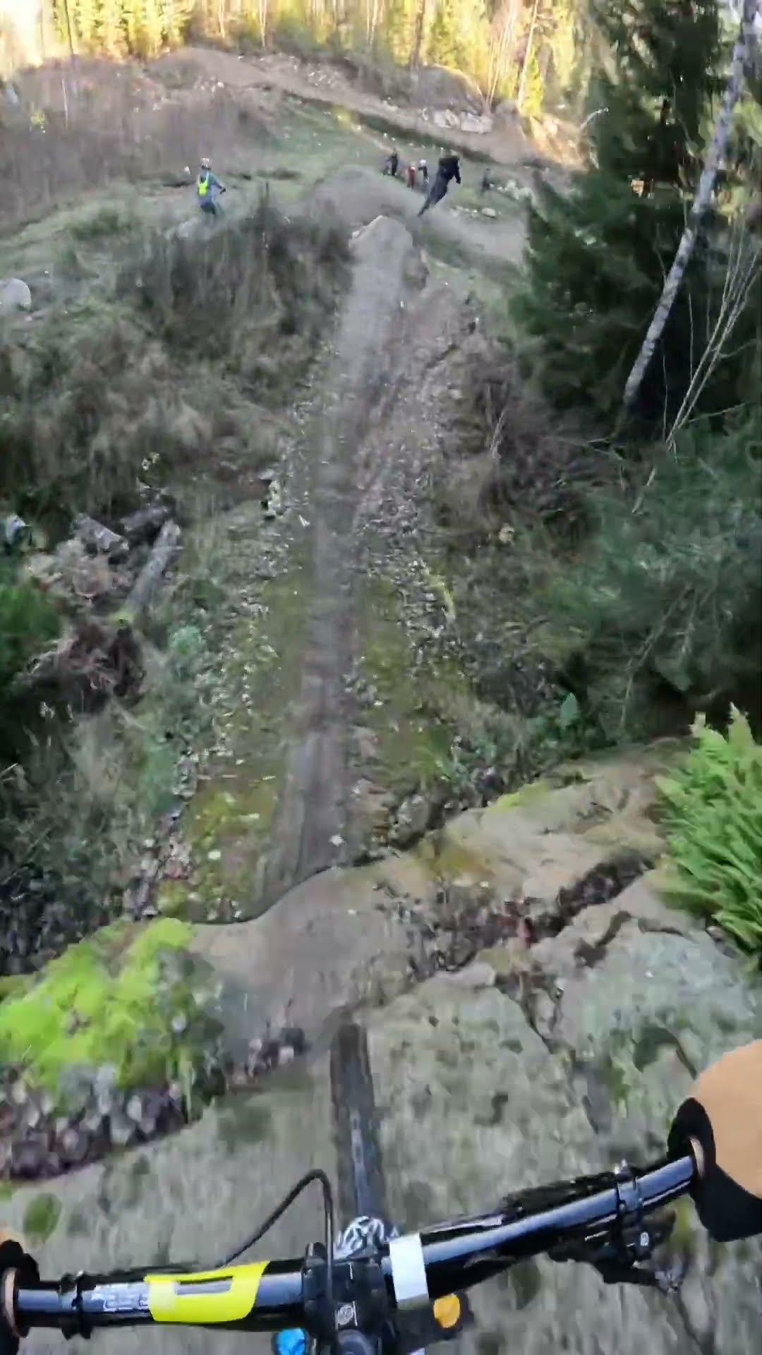 Mountain biker drops down steep rock slab