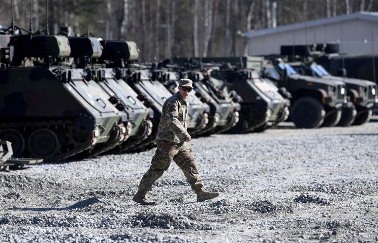 FILE PHOTO: A member of the military walks at the US army base at Grafenwoehr, Germany March 11, 2022. REUTERS/Andreas Gebert/File Photo