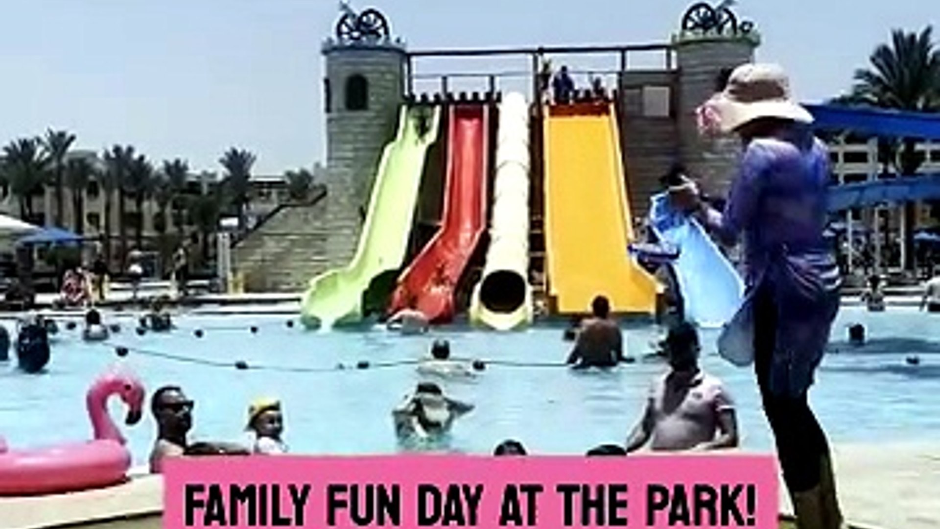 Grandpa rides down slide with hesitant granddaughter