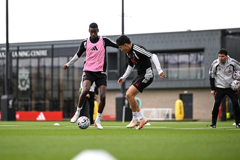 Alexander Isak and Wataru Endo of Liverpool during a training session at AXA Training Centre