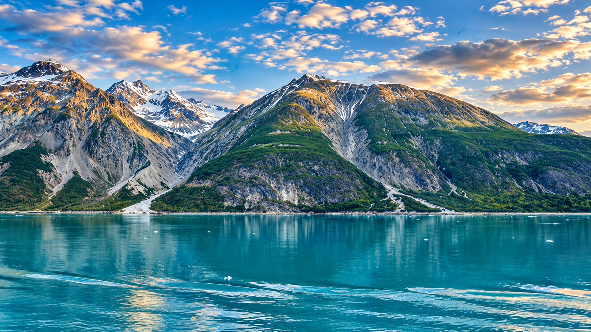 Turquoise glacier bay beneath rugged mountains