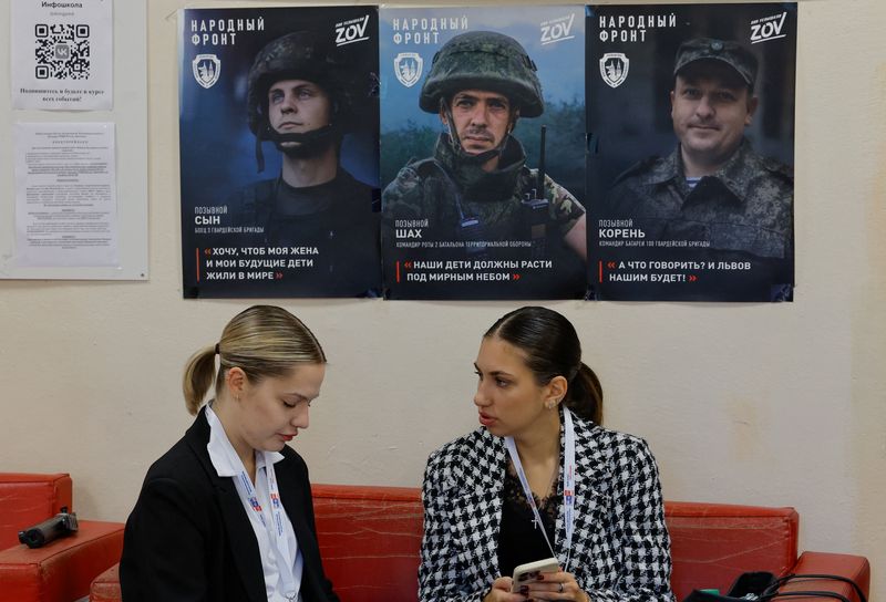Observers sit at a polling station during Russia's parliamentary elections, in the course of the Russia-Ukraine conflict in Donetsk, Russian-controlled Ukraine, September 18, 2026. REUTERS/Alexander Ermochenko