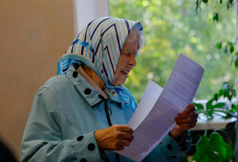A woman studies the ballot at a polling station during Russia's parliamentary elections, in the course of the Russia-Ukraine conflict in Donetsk, Russian-controlled Ukraine, September 18, 2026. REUTERS/Alexander Ermochenko