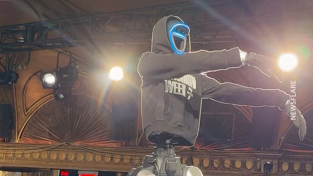 Runway robot falls dramatically off stage