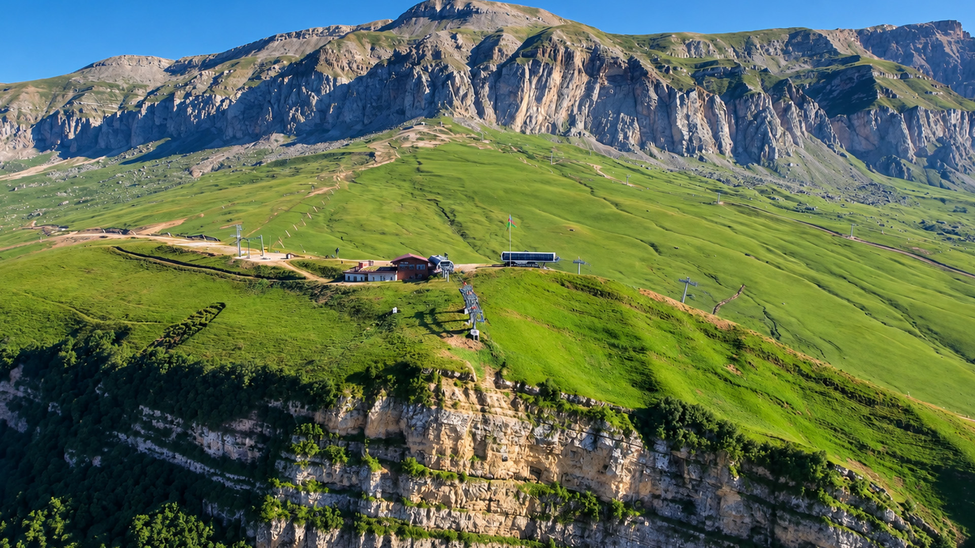 small-buildings-beneath-a-giant-mountain-wall