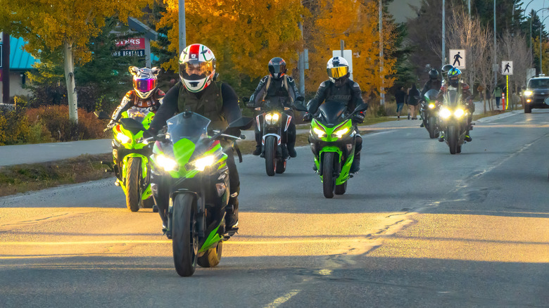 What does it mean when a biker puts their left hand up with the palm ...