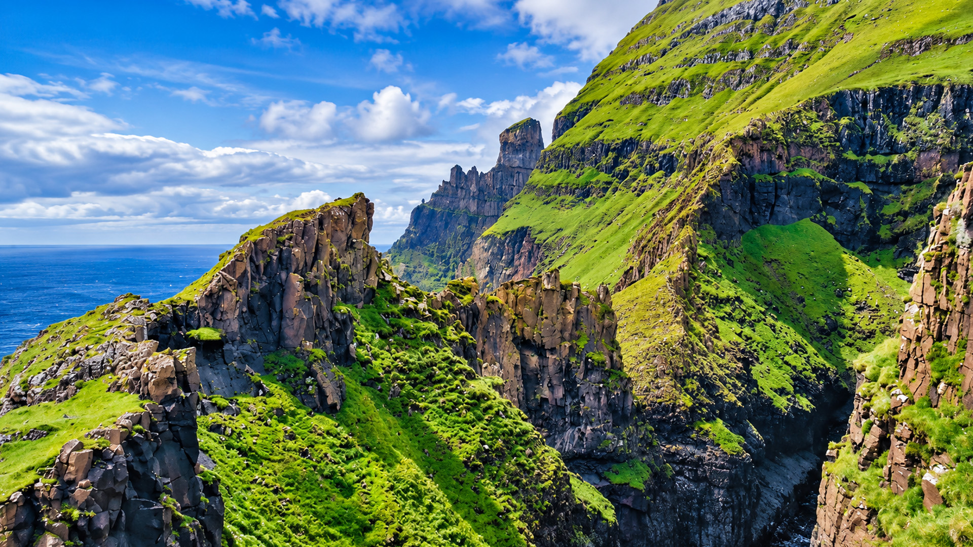 Towering rock formations along the Faroe Islands coast
