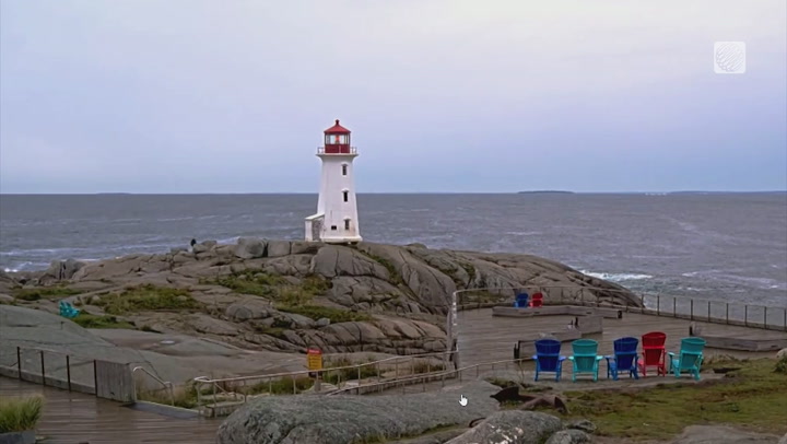 Iconic lighthouse on the rocky coast of Nova Scotia