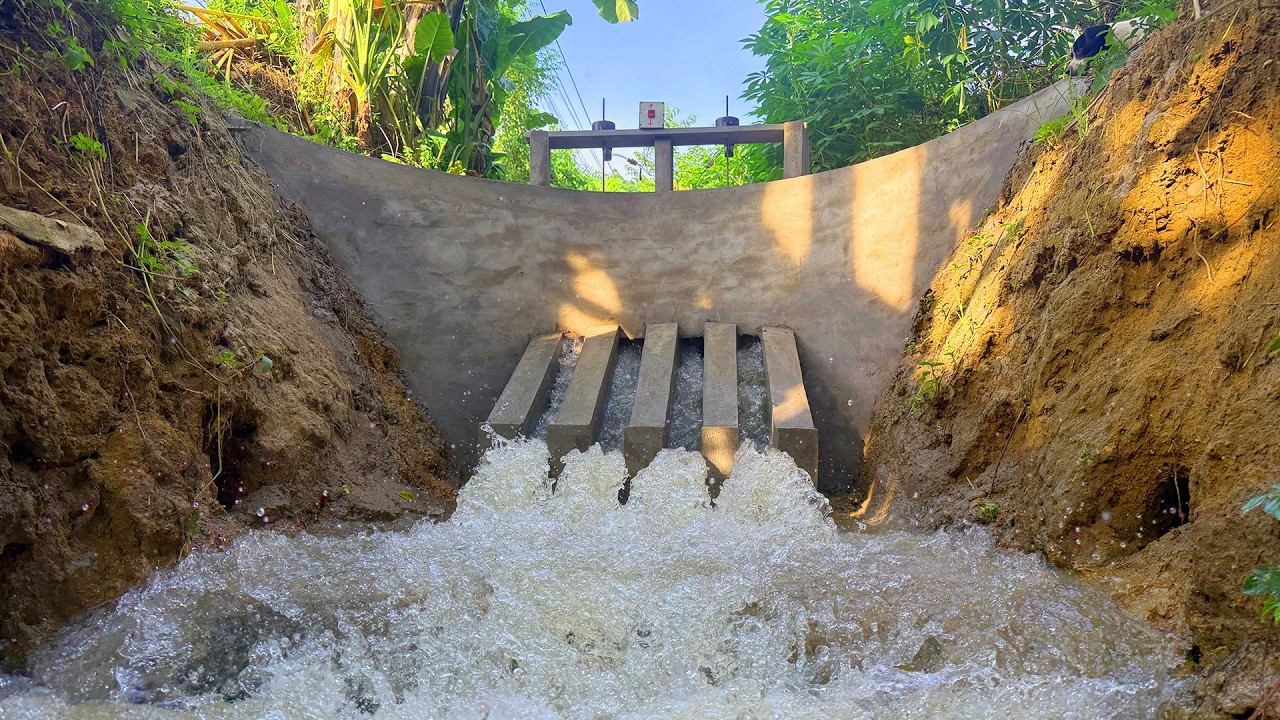 The man built a curved dam to block the flow of water, featuring four ...