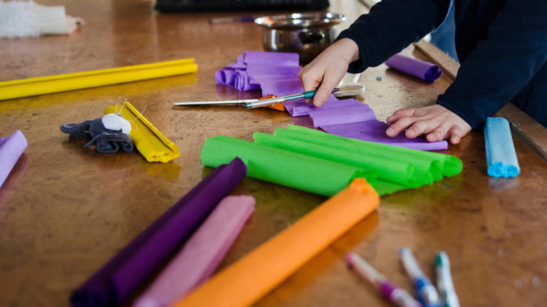 DIY a pool noodle candy corn wreath to spruce up your porch for fall