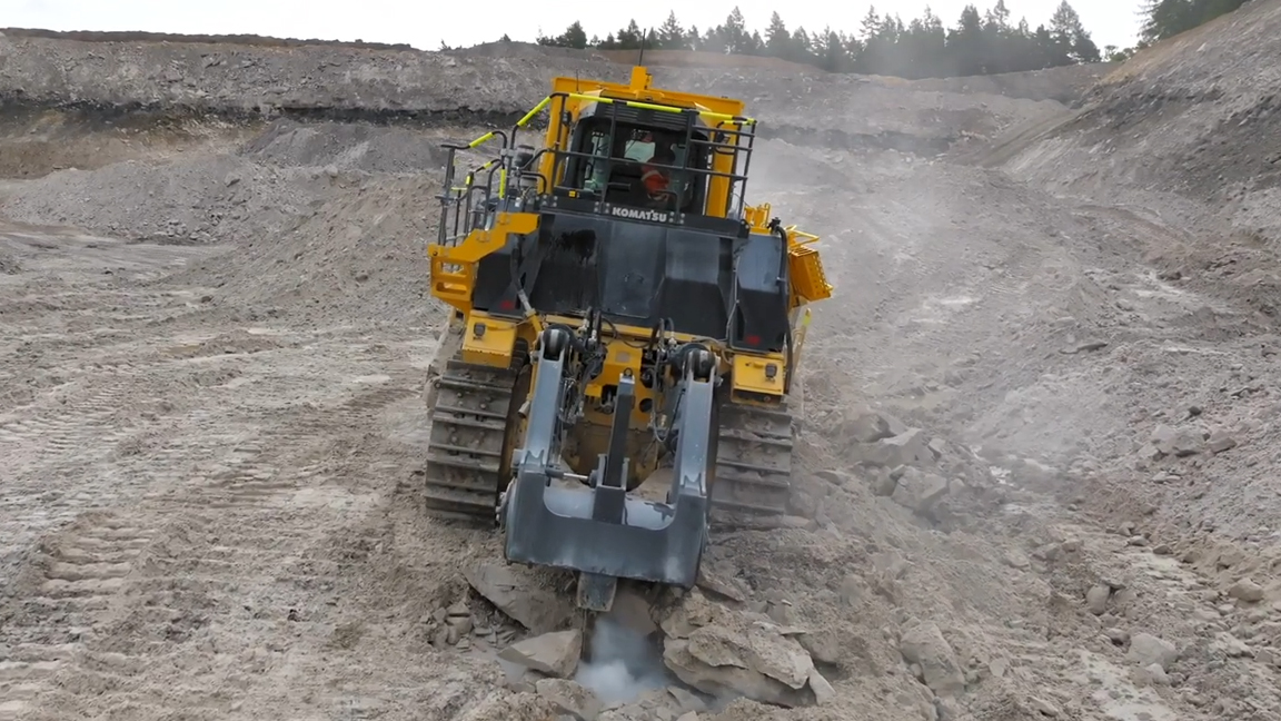 Giant crawler dozer breaking hard rock in a quarry