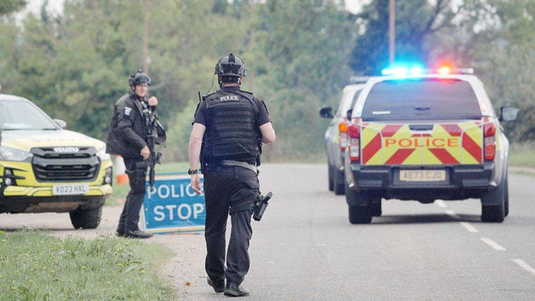 Police at a road block on the road to RAF Fairford after major incident has been declared, with armed police manning a cordon near the village of Whelford in Gloucestershire, near RAF Fairford which is used by the United States Air Force (USAF). Picture date: Sunday September 27, 2026. Getty Images