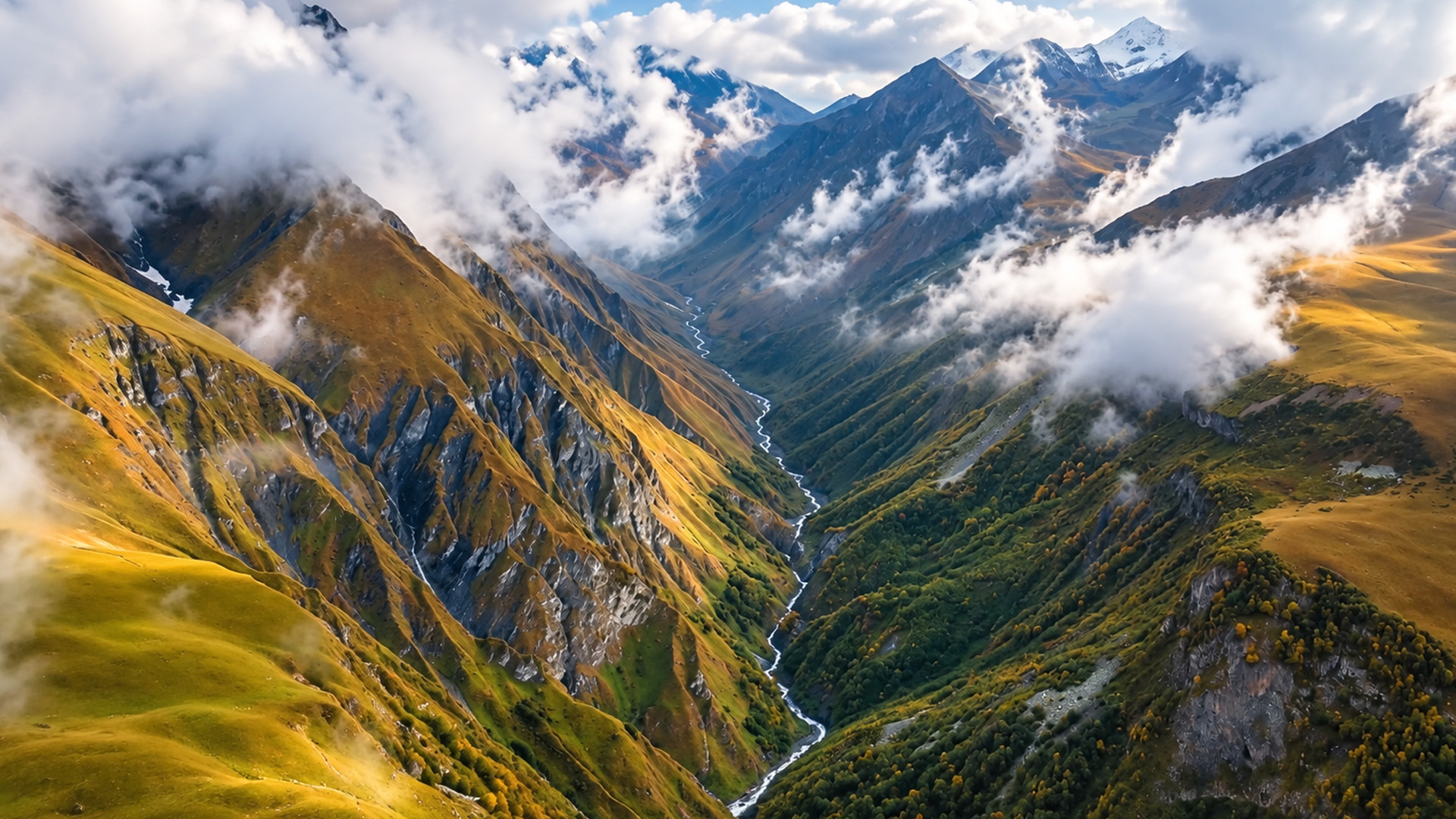 What lies beyond these cloud-covered mountain ridges?