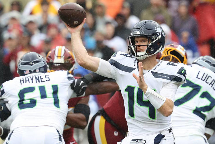 Seattle Seahawks quarterback Sam Darnold drops back to pass against the Washington Commanders. | IMAGN IMAGES via Reuters Connect