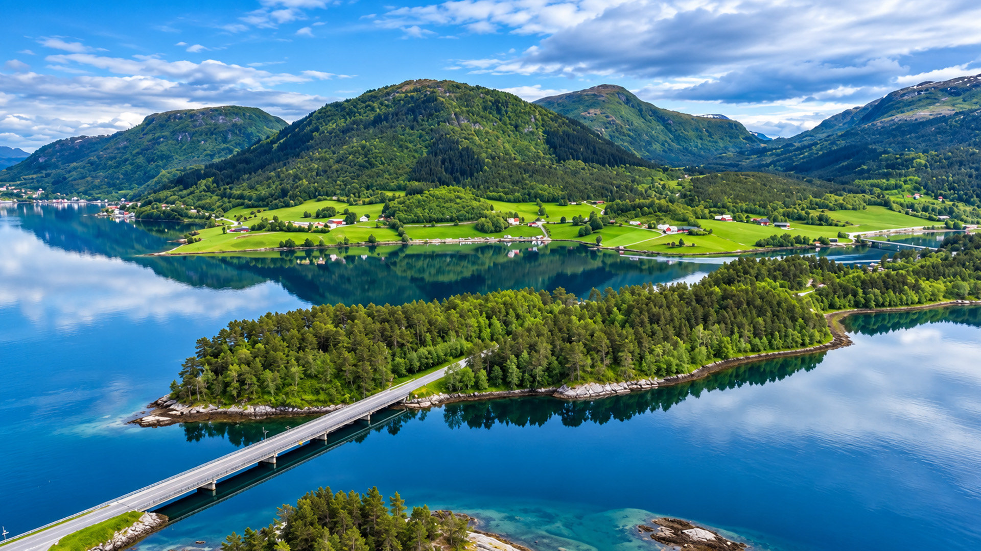 Norwegian fjord beneath towering green mountains