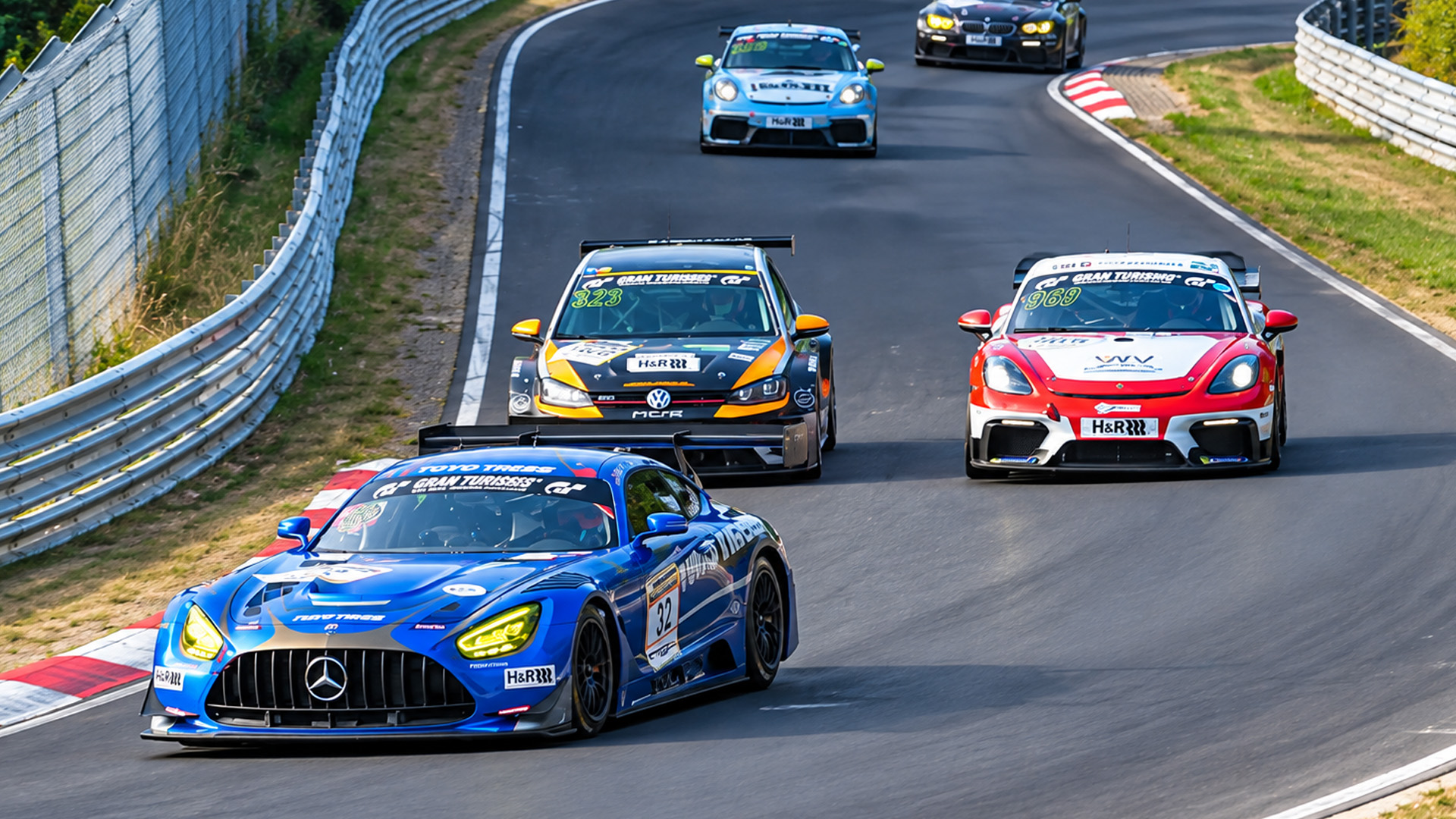 GT3 race cars battle closely at high speed at Nürburgring