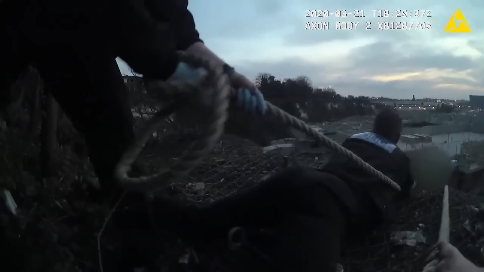 A man was hanging above a 50-foot drop… officers linked their belts ...
