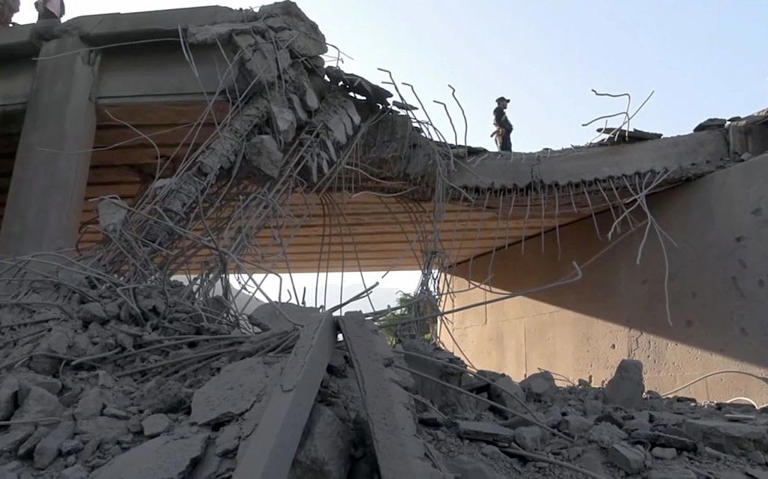  In this handout photo provided by Houthi Media Center, people inspect Al-Dalil Bridge following an aerial attack carried out by a Saudi war jet targeted it on September 26, 2026 in Ibb province, Yemen. 