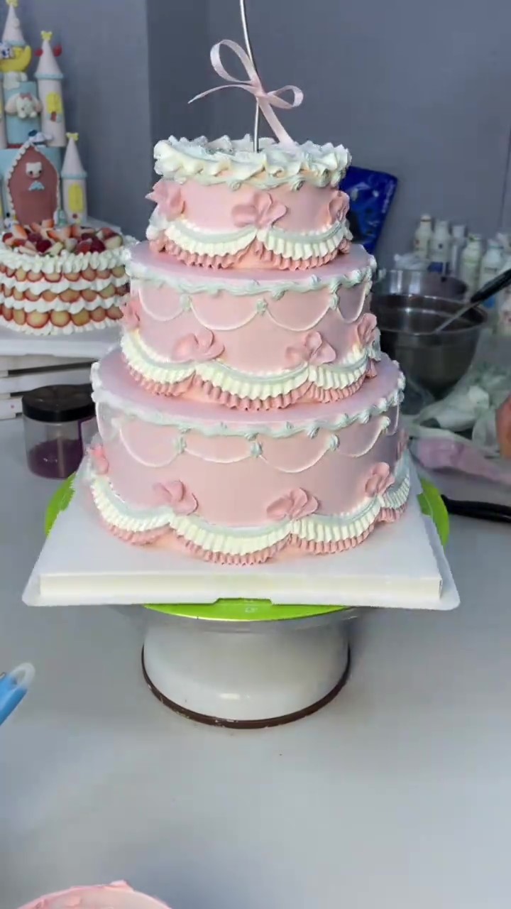 Dreamy pink vintage cake is covered in delicate bows and piped details
