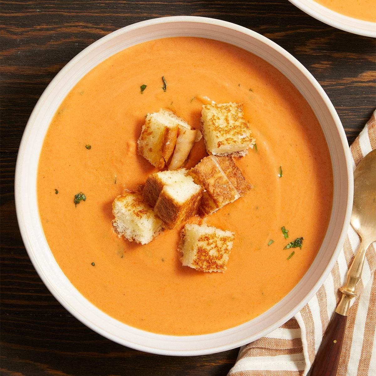 Creamy sun-dried tomato soup with grilled cheese croutons