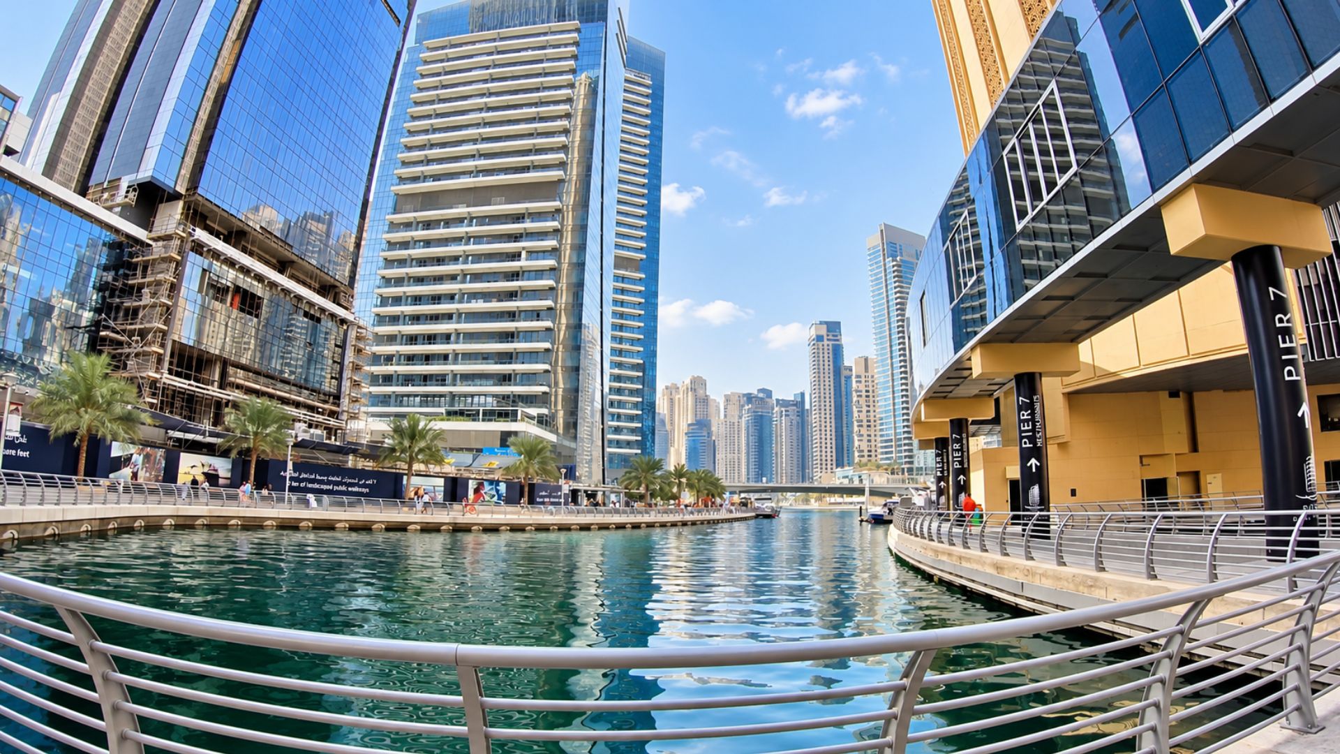 Dubai Marina walk between skyscrapers and calm waterways (4K)