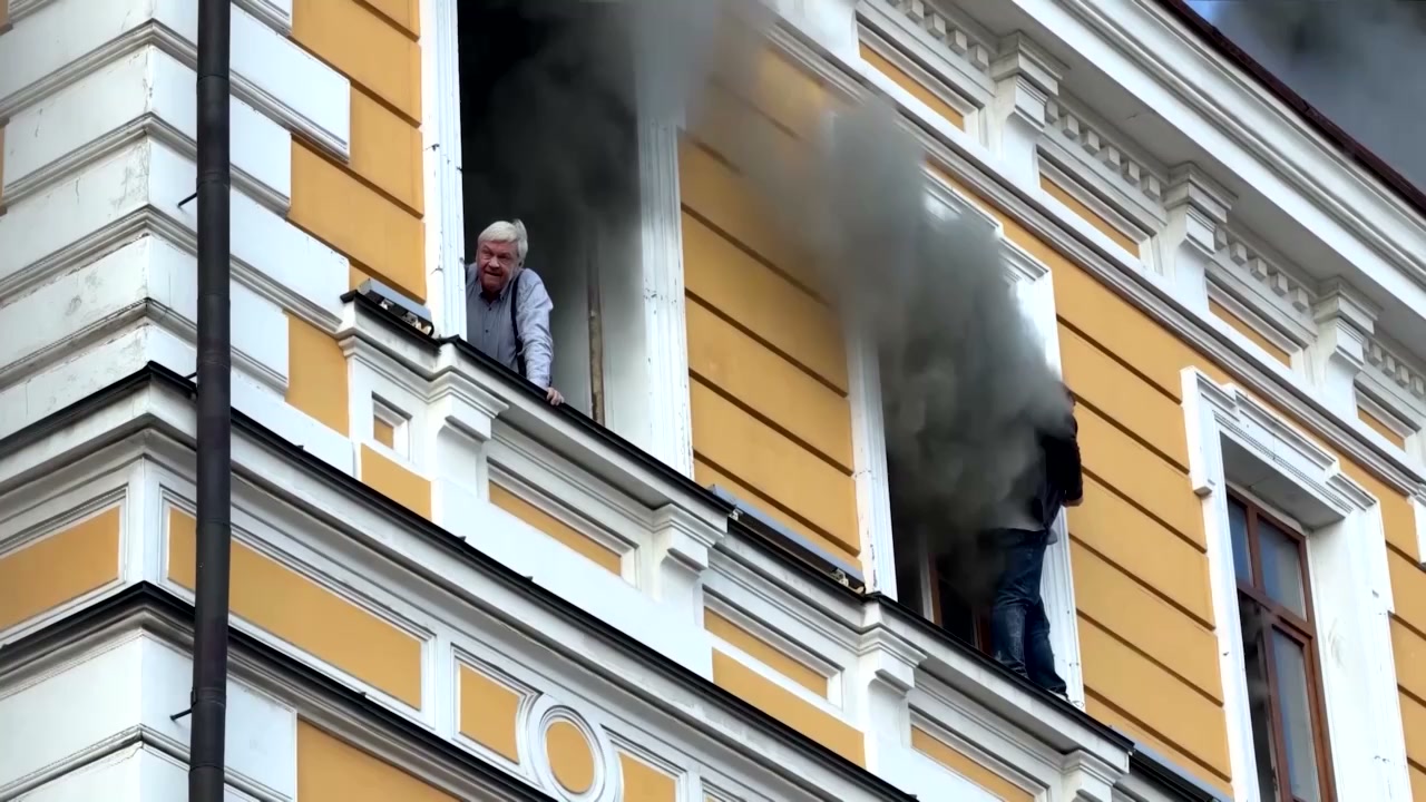 Men cling to side of burning Kyiv building after Russian drone strike