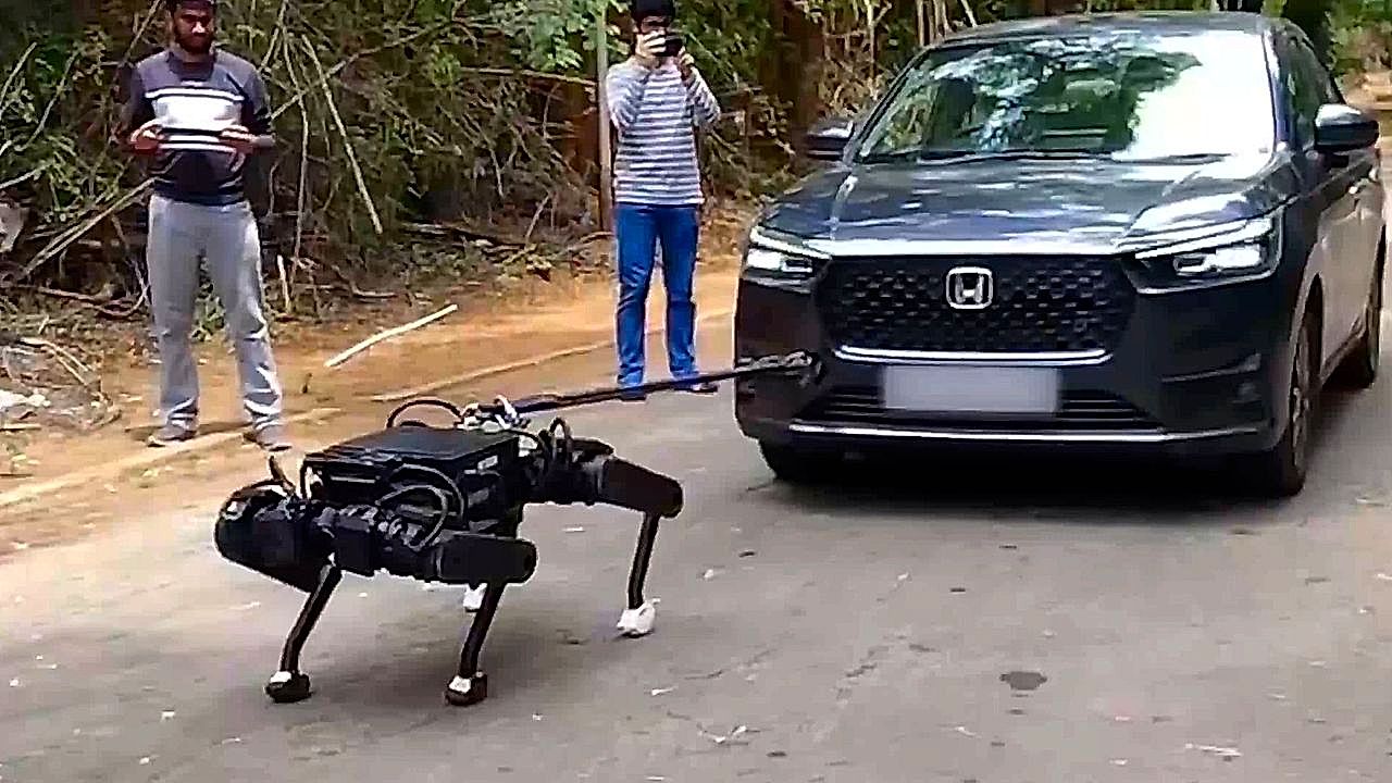 Robot dog pulls a sedan with two passengers inside in show of strength