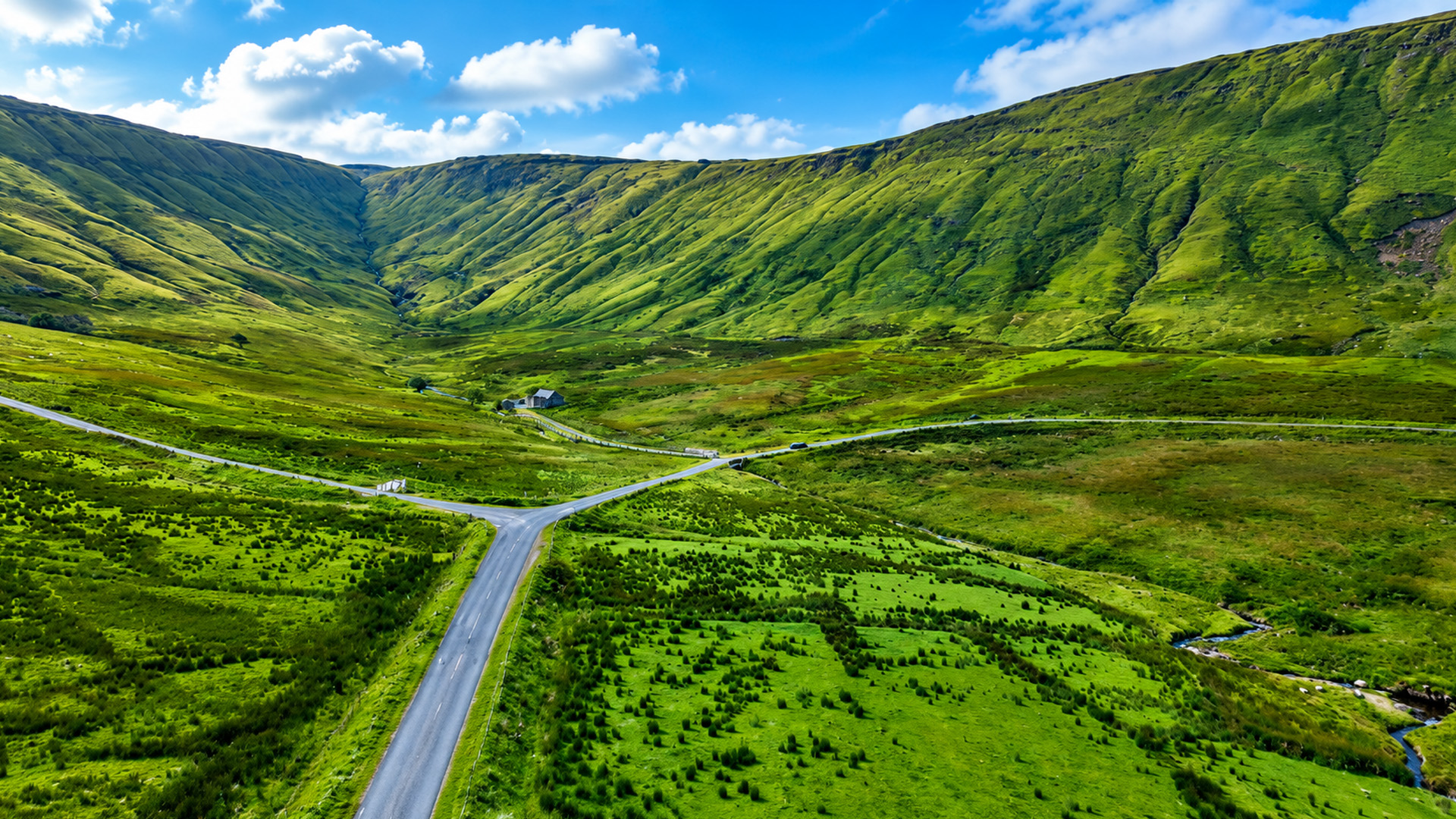 A narrow road winding between Ireland’s giant mountains