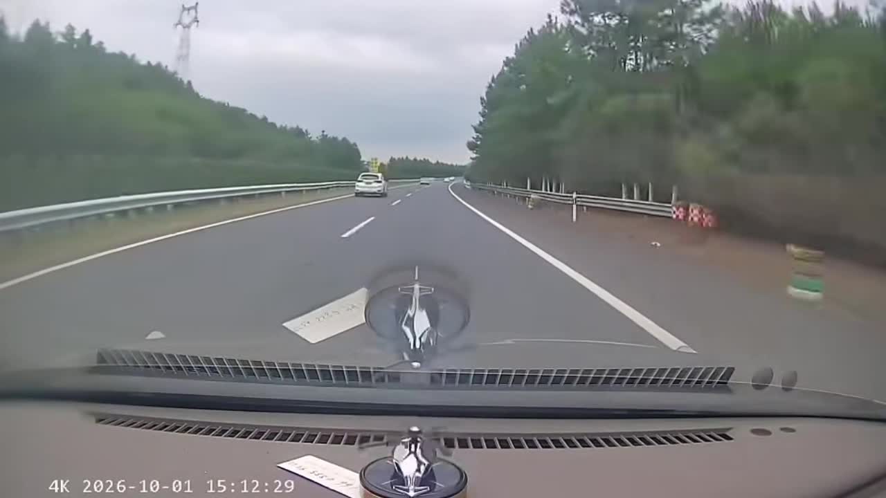 Car wobbles across the highway before crashing into the guardrail in ...