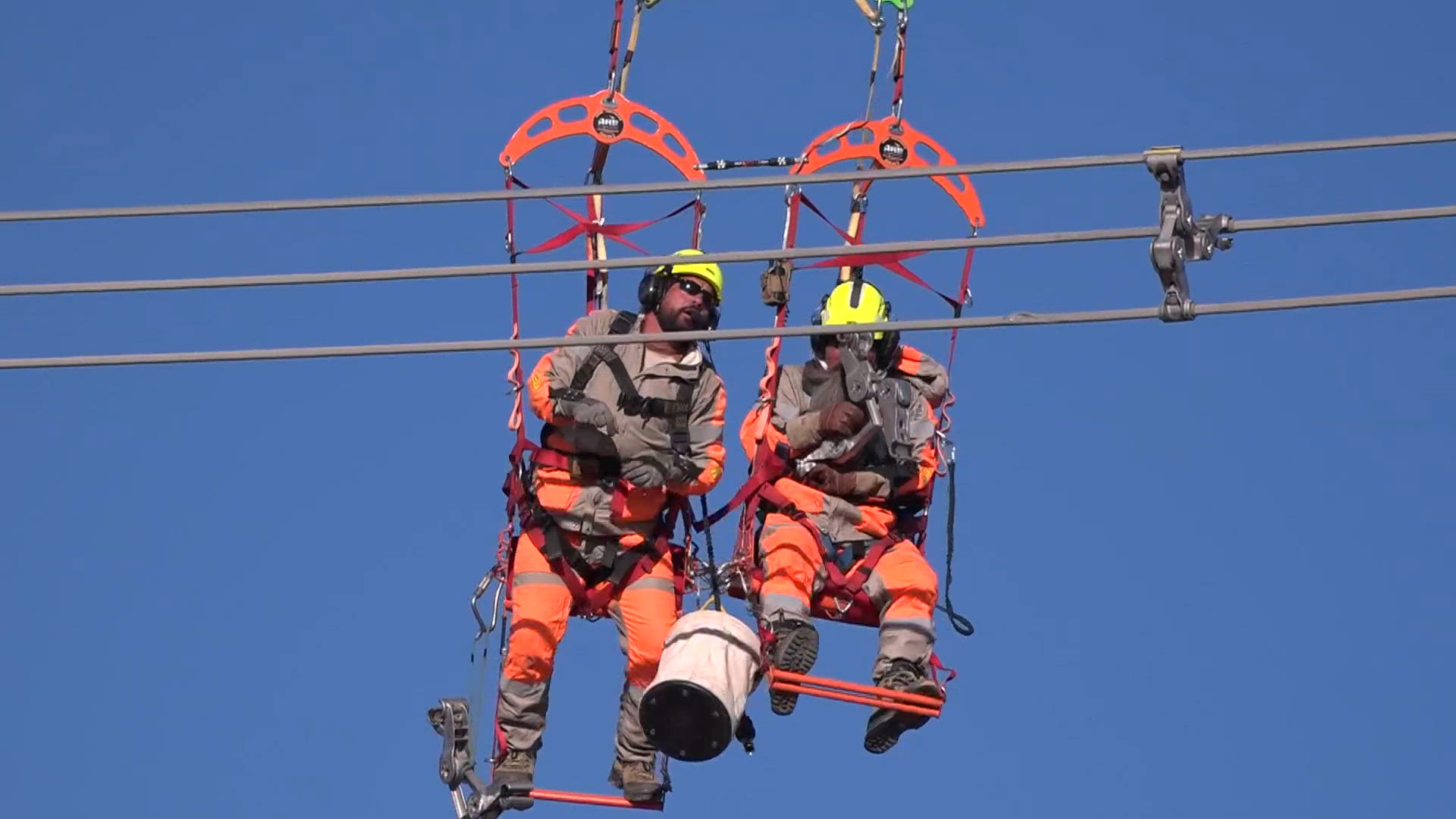 SRP using helicopter to hoist crews up to power lines