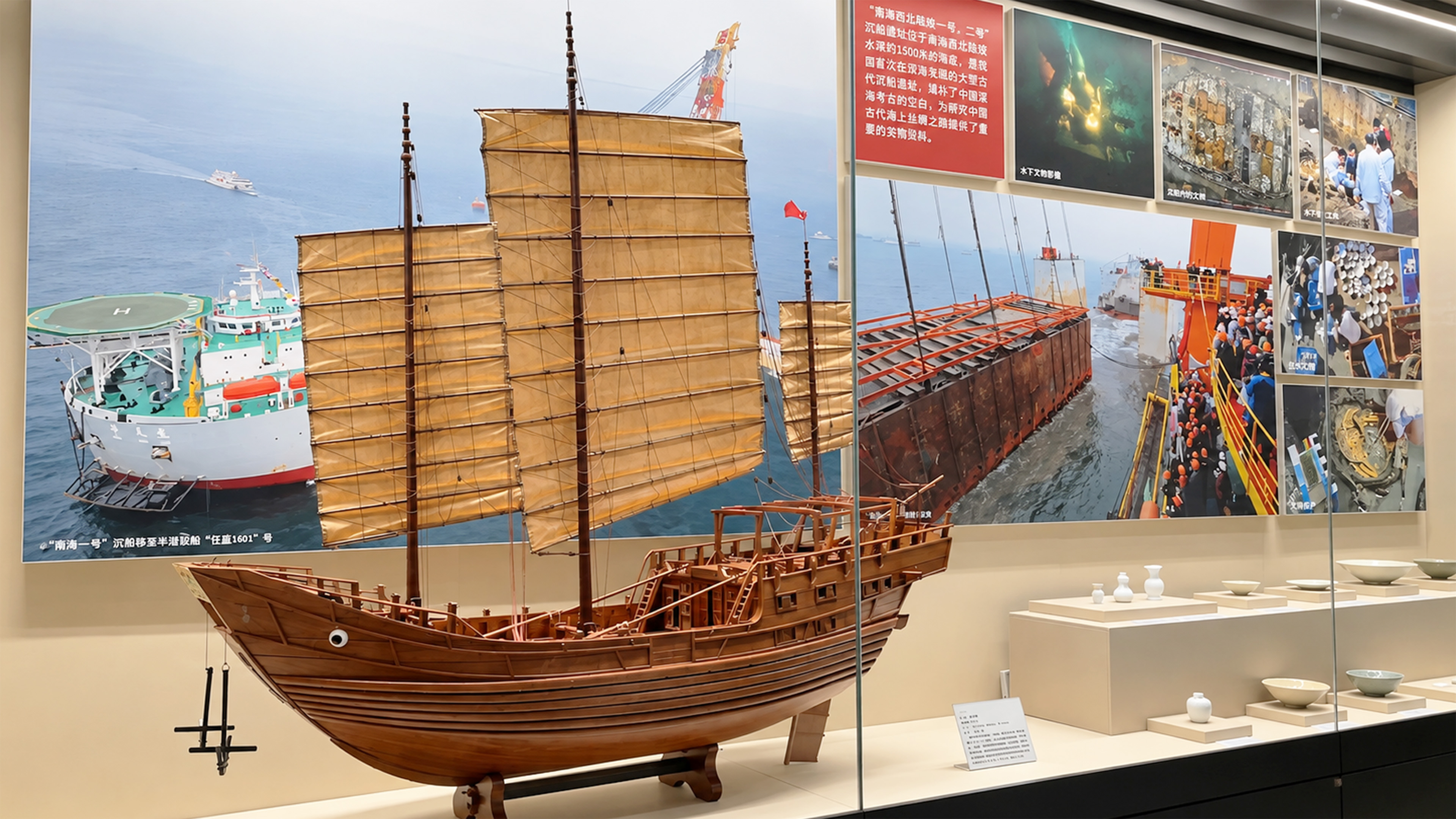 An ancient sailing ship appears beside modern vessels in China
