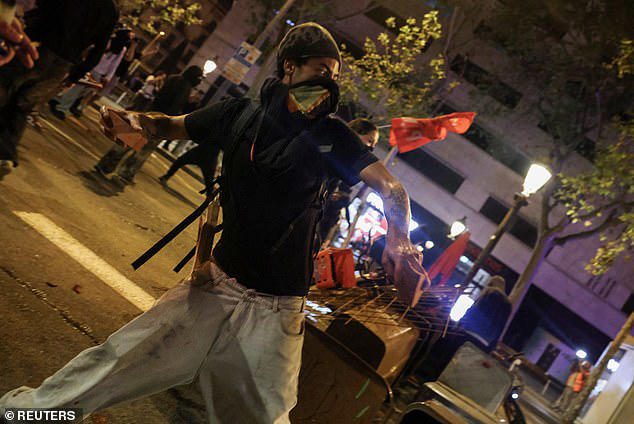 Protesters battle Spanish police as demonstrations over spiralling ...