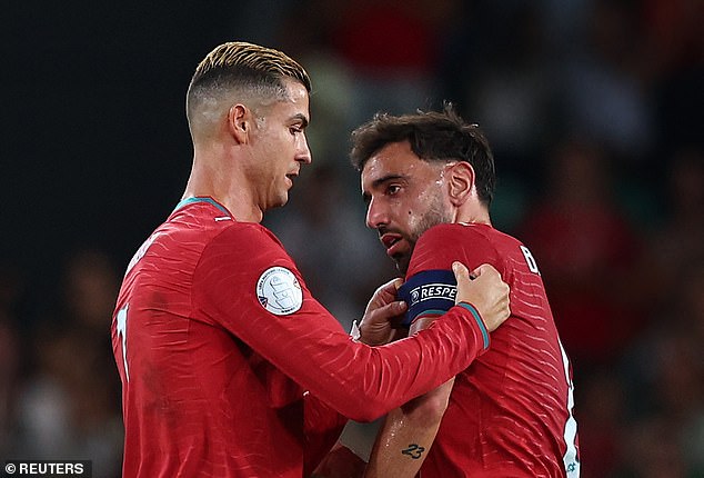 Bruno Fernandes (right) has held clear-the-air talks with Ronaldo after the latter stormed out of the Portugal camp