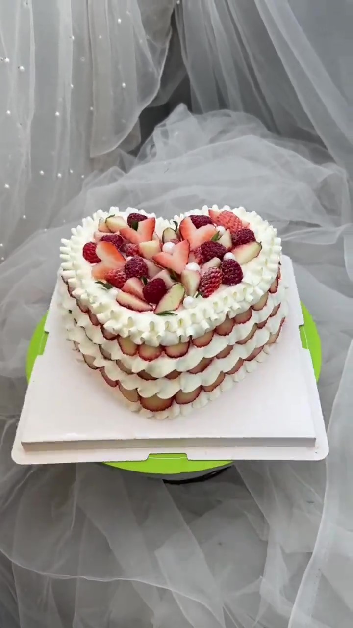 Beautiful strawberry heart cake is loaded with fresh berries