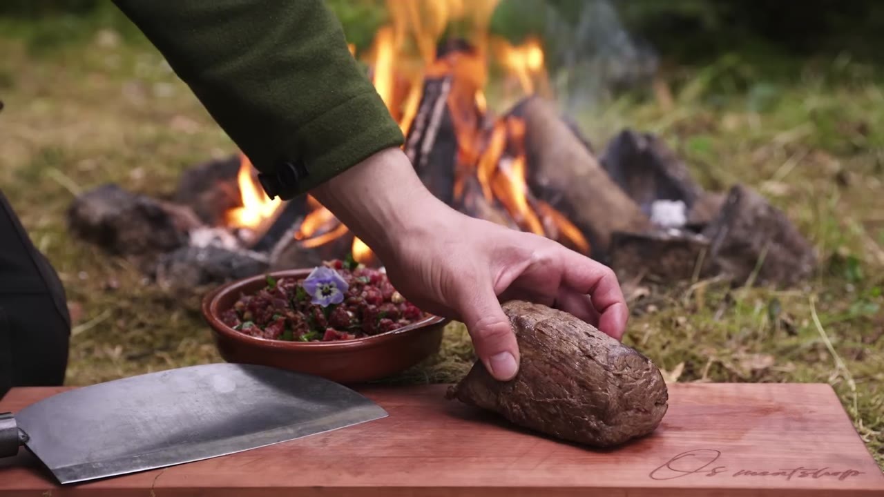 He uses a salt plank as the cooking surface for a huge beef tenderloin