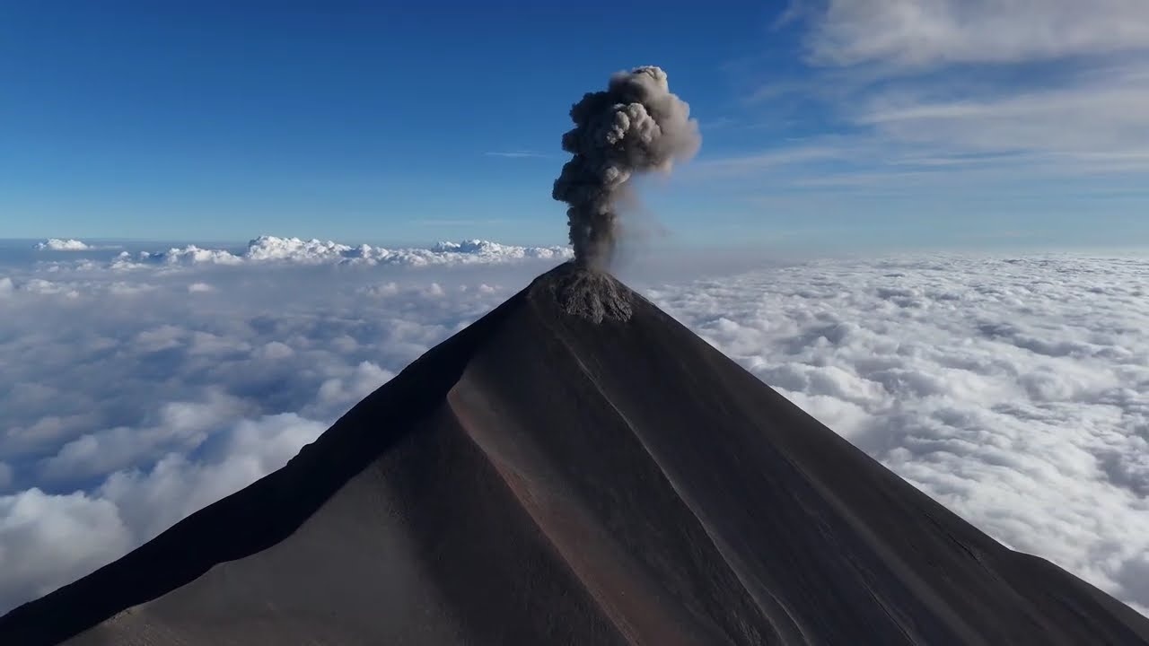 Drone captures Guatemala's active Volcán de Fuego rising above the clouds