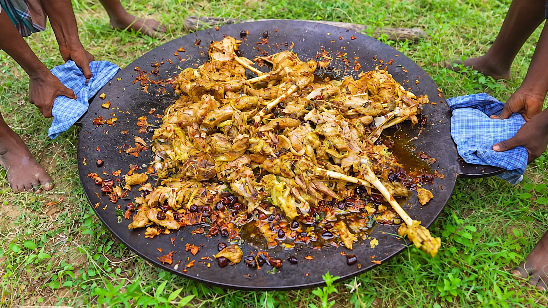 Traditional full goat leg mutton uppu kari fry cooked outdoors